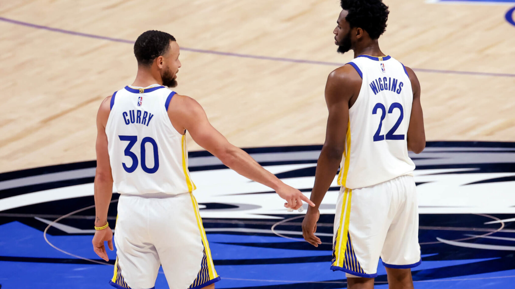 Golden State Warriors teammates Stephen Curry and Andrew Wiggins high-fiving