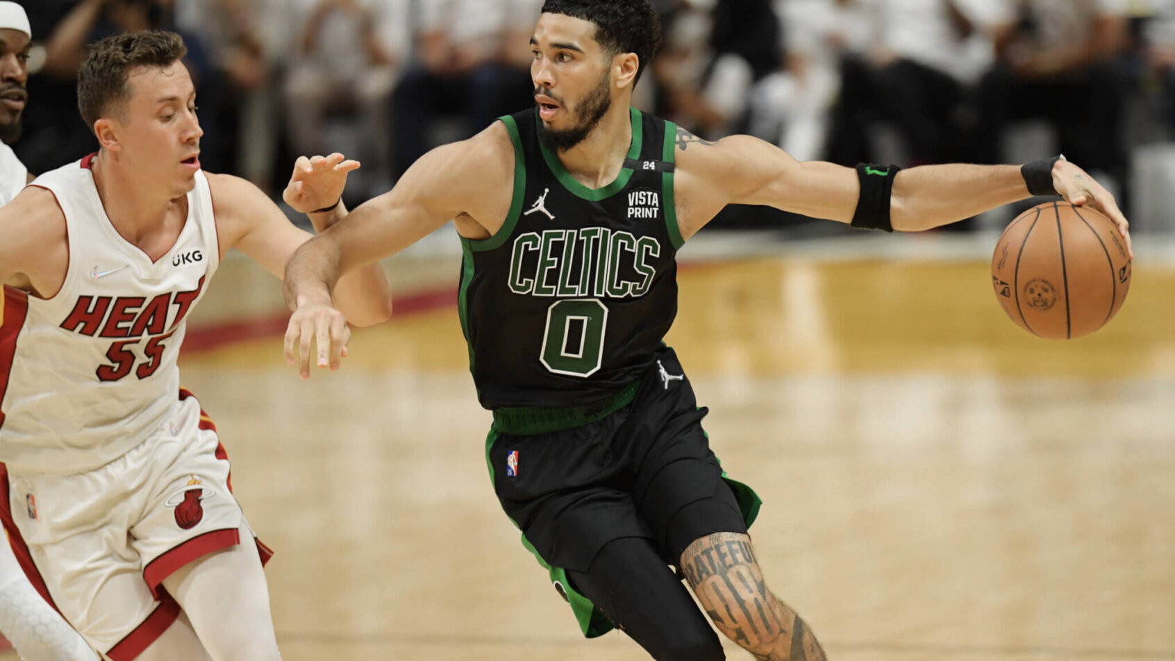 Jayson Tatum dribbling against defender