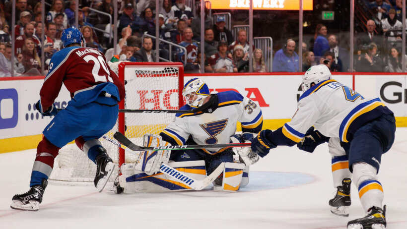 Colorado center Nathan MacKinnon scoring a goal on St Louis goalie Ville Husso