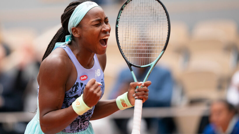 Coco Gauff celebrating with a first pump after winning a match at the French Open.