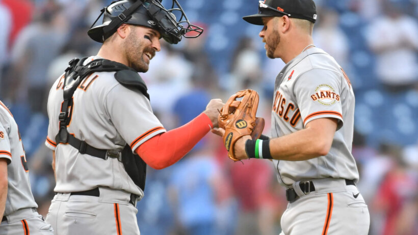 San Francisco Giants catcher Curt Casali fist bumps third baseman Evan Longoria