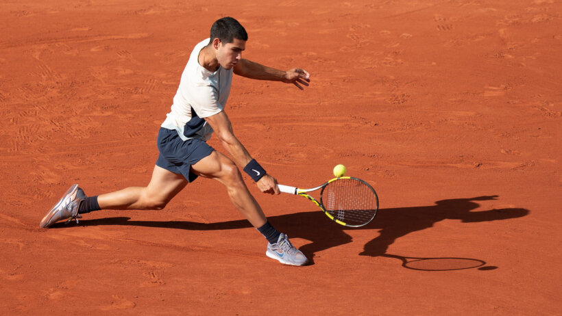 Carlos Alcaraz hitting a backhand