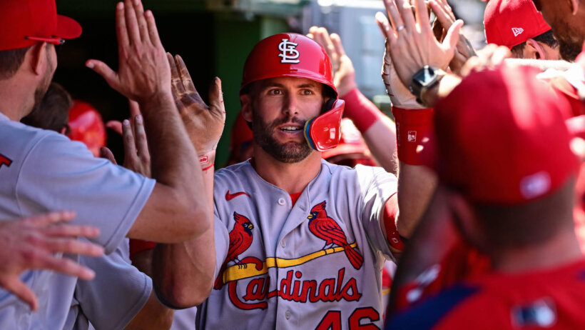 Paul Goldschmidt celebrating in the dugout with teammates.