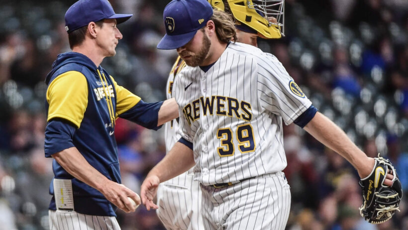 Milwaukee Brewers manager Craig Counsell takes the ball from pitcher Corbin Burnes