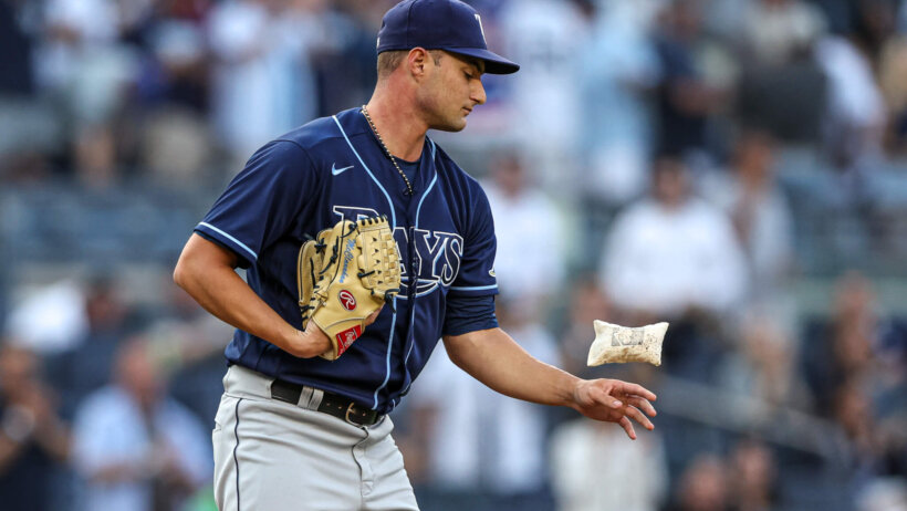 Tampa Bay Rays starting pitcher Shane McClanahan flipping a rosin bag