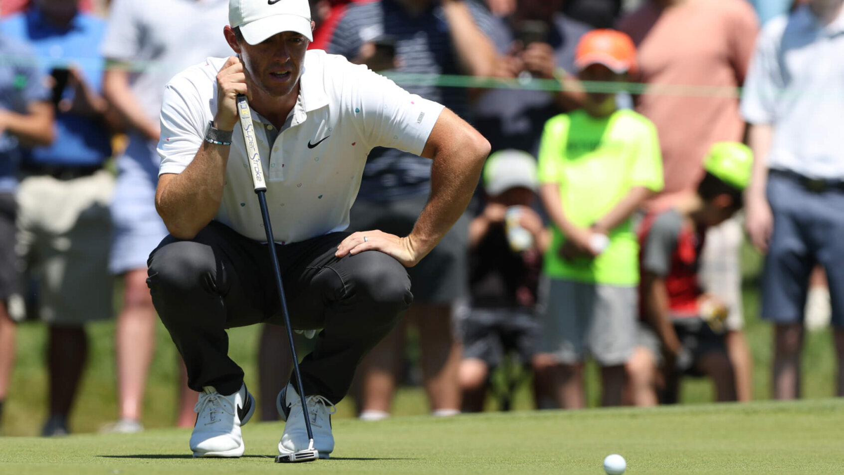 Rory McIlroy looks over a putt