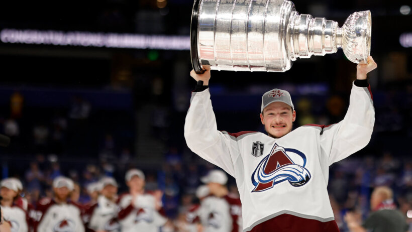 Colorado Avalanche defenseman Cale Makar celebrating with the Stanley Cup