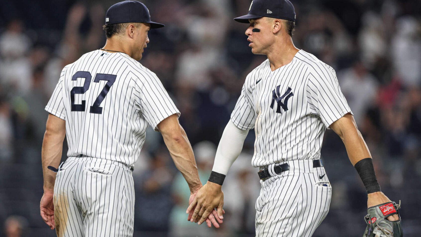 New York Yankees center fielder Aaron Judge high-fives designated hitter Giancarlo Stanton