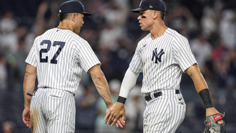 New York Yankees center fielder Aaron Judge high-fives designated hitter Giancarlo Stanton