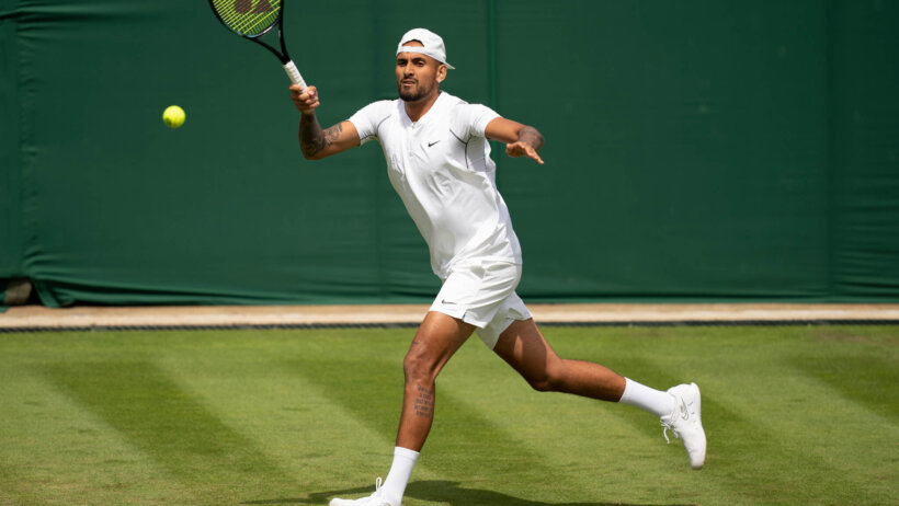 Nick Kyrgios (AUS) returns a shot during her first round match against Paul Gubb on day two of Wimbledon