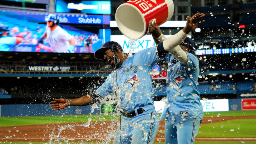 Vladimir Guerrero Jr dumping water on Teoscar Hernandez after a Blue Jays win