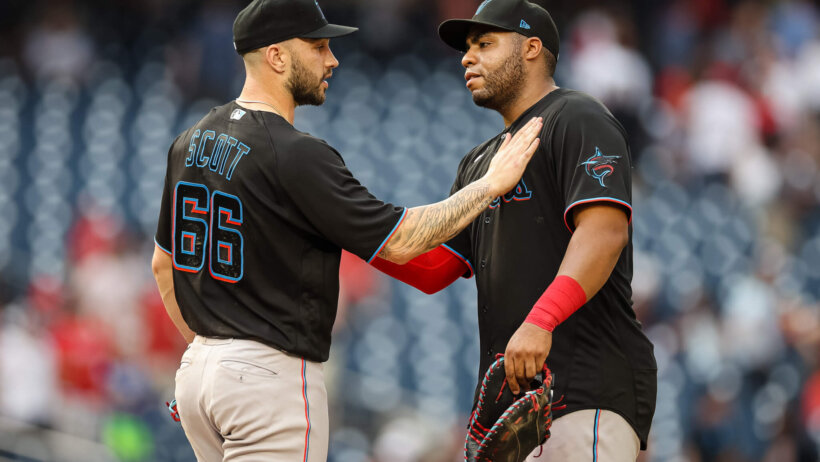 Miami Marlins pitcher Tanner Scott celebrates with teammate Jesus Aguilar