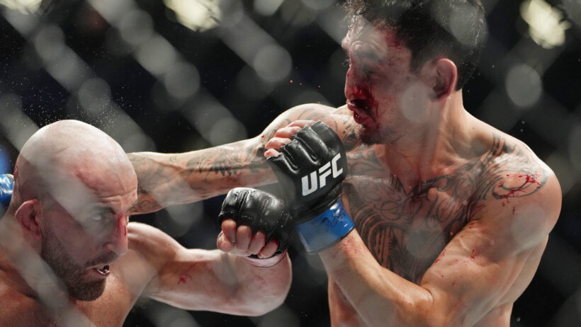 Max Holloway throws a punch at Alexander Volkanovski