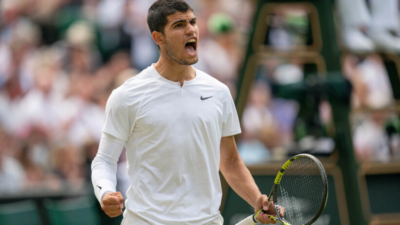 Carlos Alcaraz celebrating a point during a Wimbledon match.