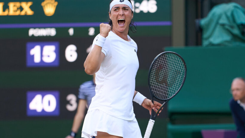 Ons Jabeur celebrating with a fist pump during a match at Wimbledon.