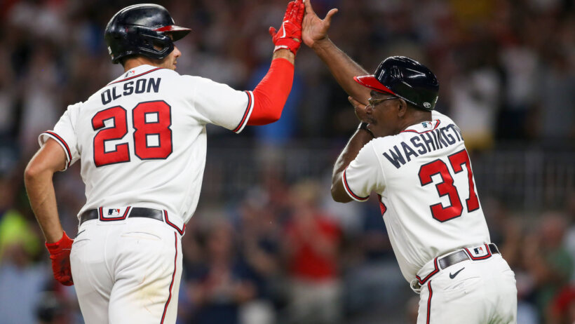 Atlanta Braves first baseman Matt Olson high-fiving his third-base coach