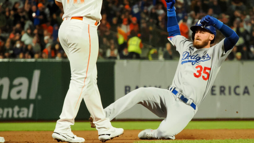 Cody Bellinger sliding into third base