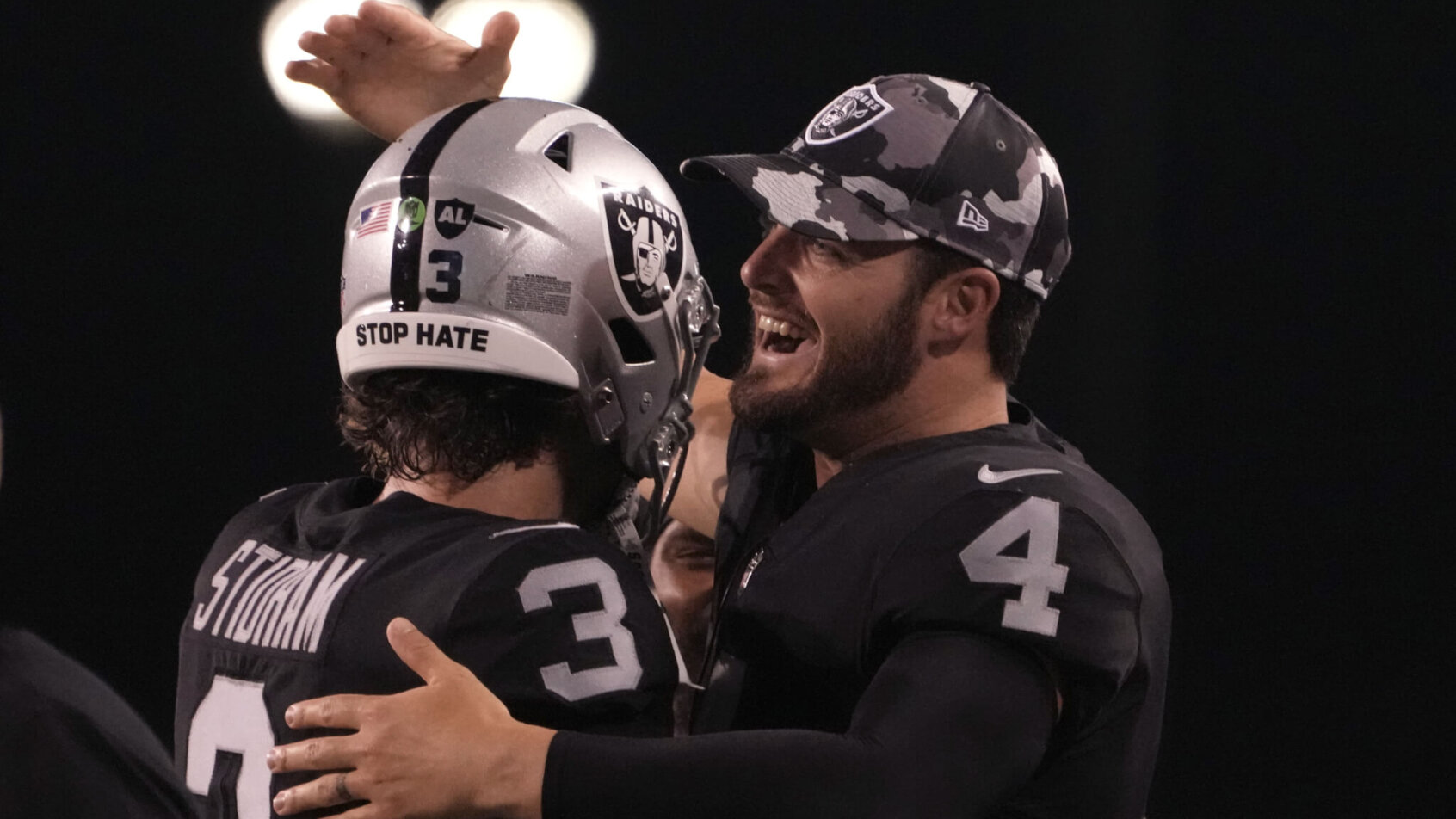 Jarrett Stidham hugs Derek Carr