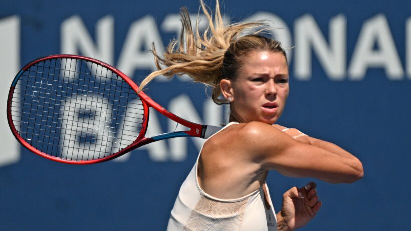 Camila Giorgi hitting a forehand shot during a tennis match.