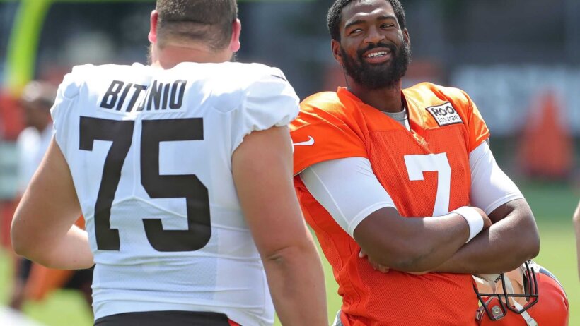 Jacoby Brissett arms folded talking to Joel Bitonio