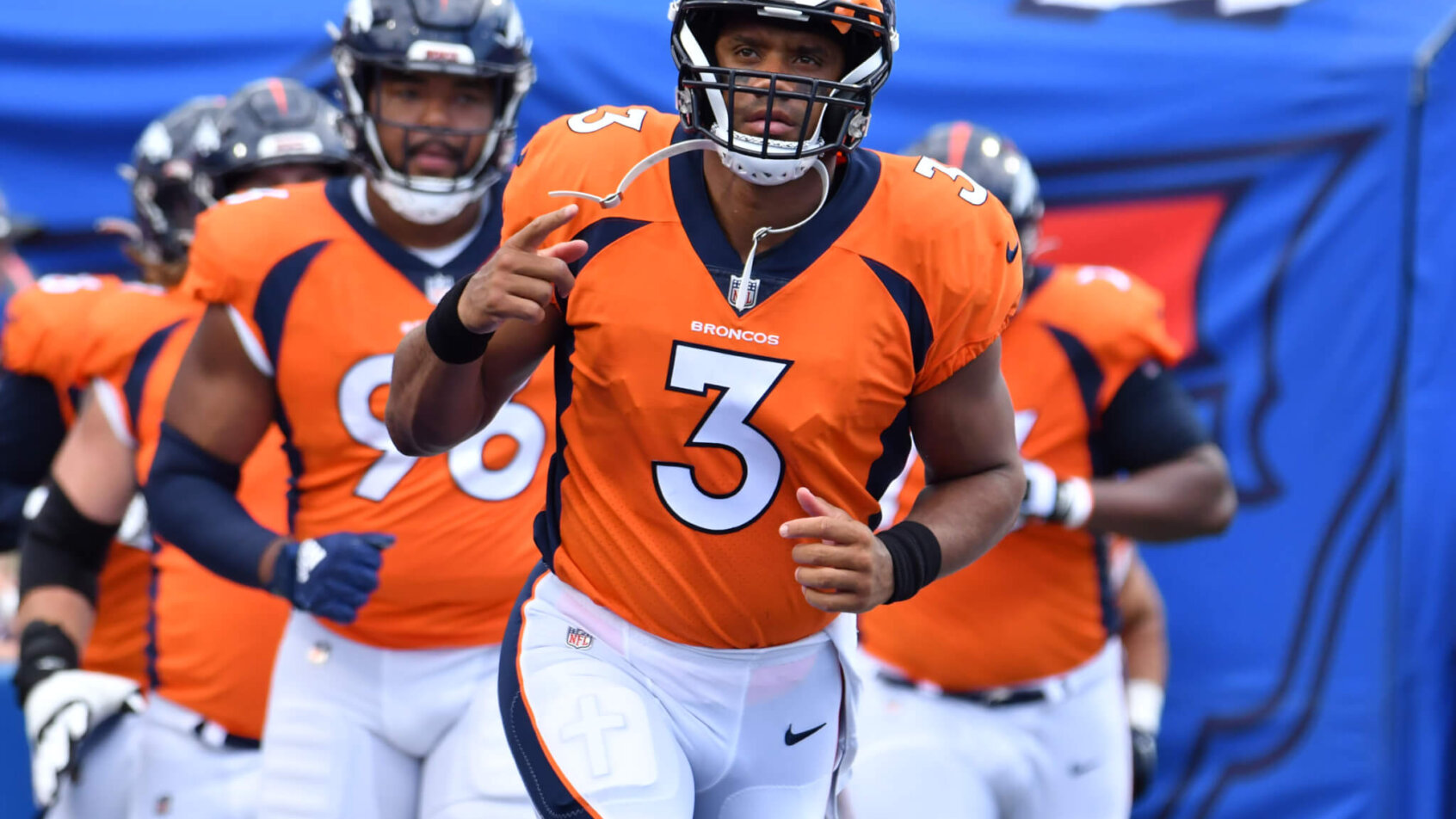 Russell Wilson leads the Broncos out onto the field