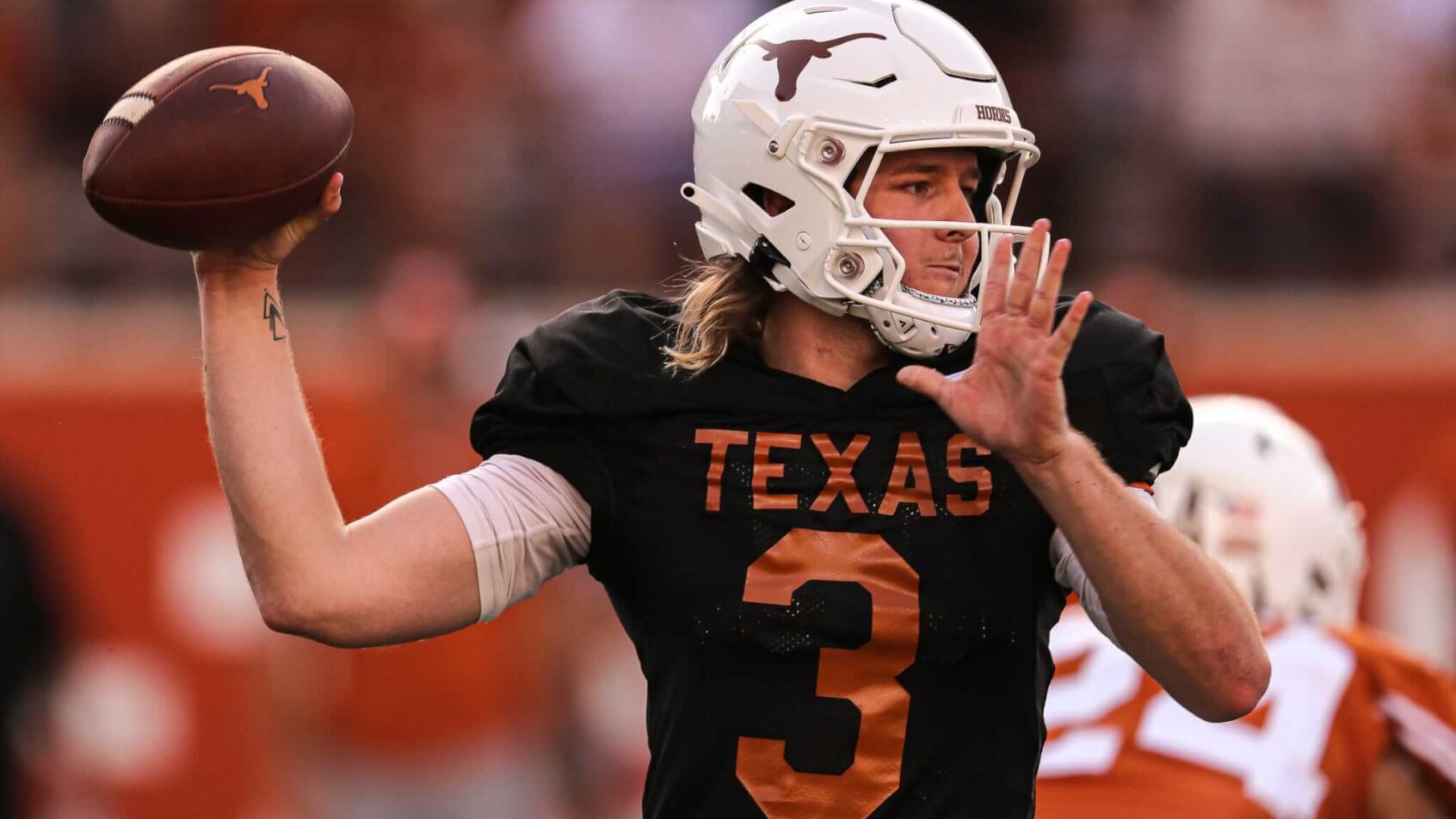 Quinn Ewers, a candidate in the Heisman odds, throws the football in practice