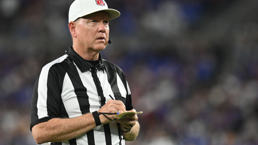 Referee Carl Cheffers writing on a piece of paper