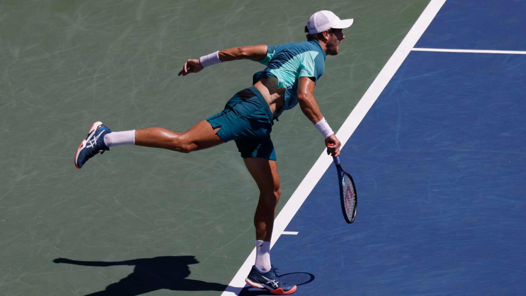 Borna Coric hitting a serve during a tennis match.
