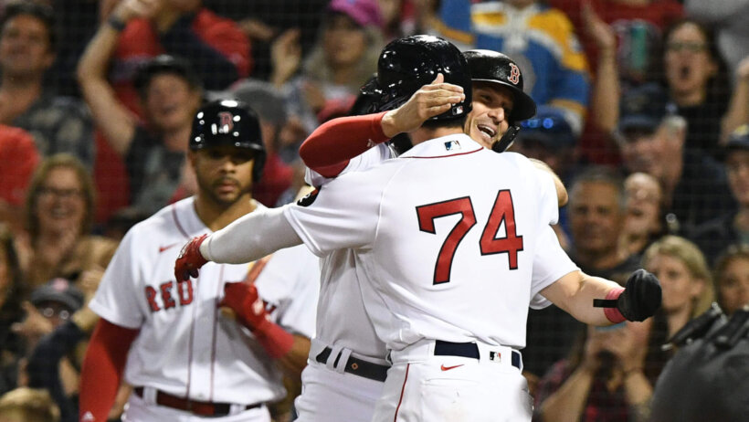 Boston Red Sox players celebrating after hitting a homerun.