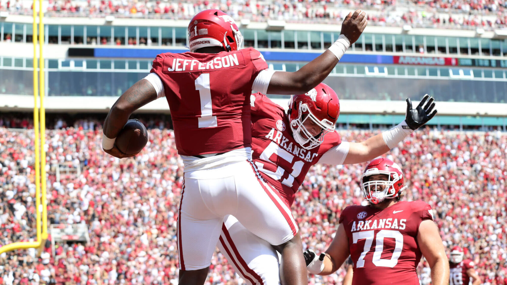 Arkansas Razorbacks quarterback KJ Jefferson celebrates with offensive lineman Ricky Stromberg