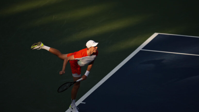 Denis Shapovalov hitting a serve during a tennis match.
