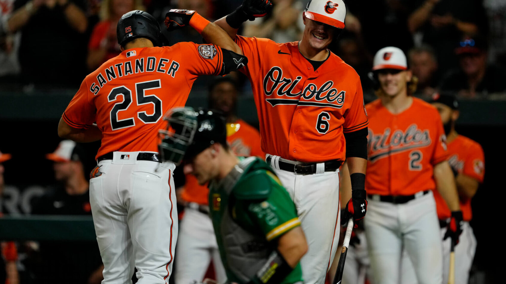 Baltimore Orioles players celebrating with one another after a homerun.