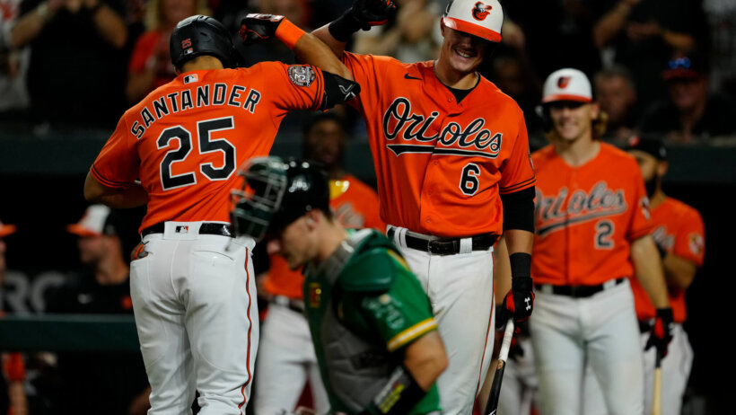 Baltimore Orioles players celebrating with one another after a homerun.