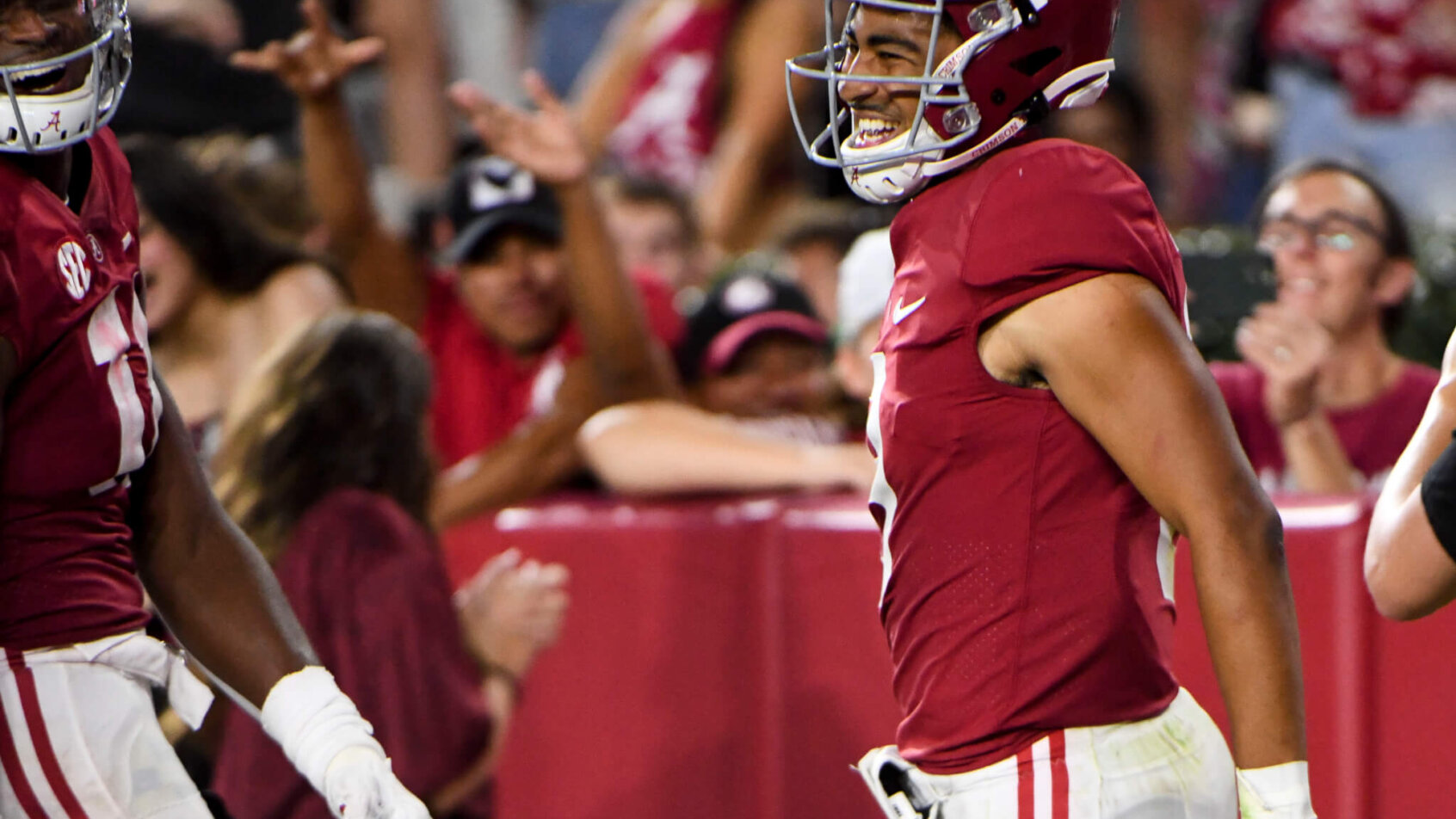 n Tide quarterback Bryce Young celebrates after scoring a touchdown
