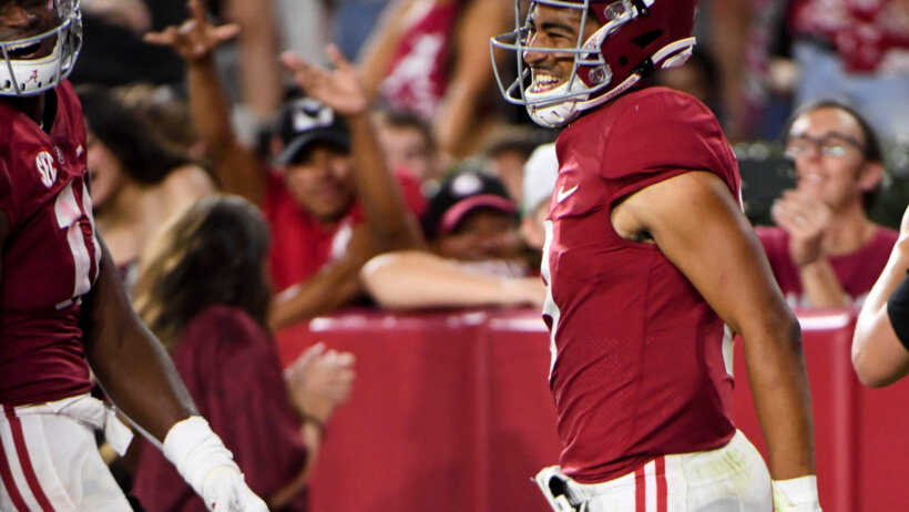 n Tide quarterback Bryce Young celebrates after scoring a touchdown