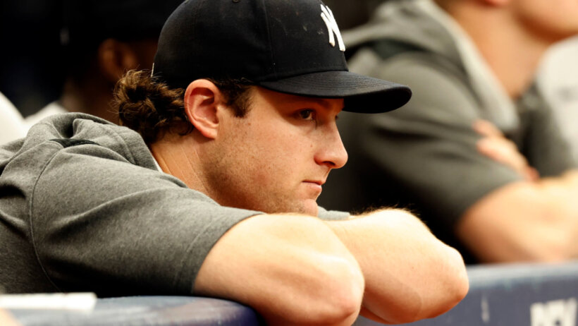 New York Yankees pitcher Gerrit Cole watches from the dugout