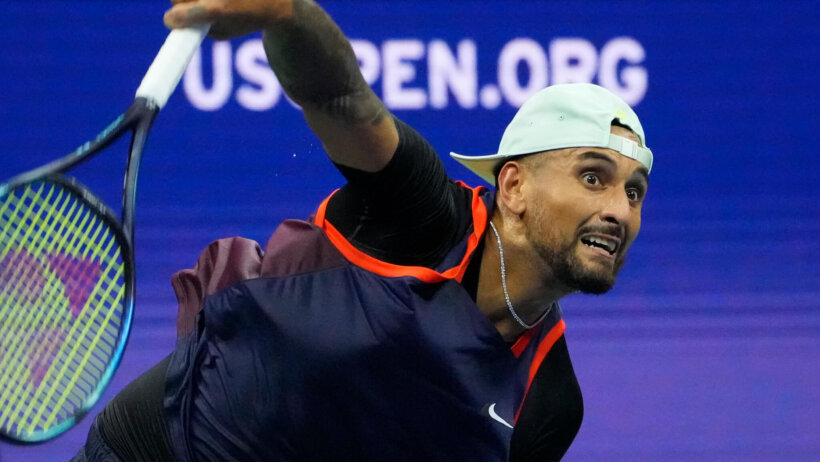 Nick Kyrgios hitting a serve during a tennis match.