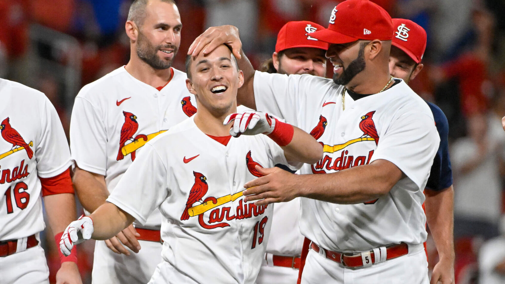 St. Louis Cardinals shortstop Tommy Edman is congratulated by teammates after hitting a game-winning double