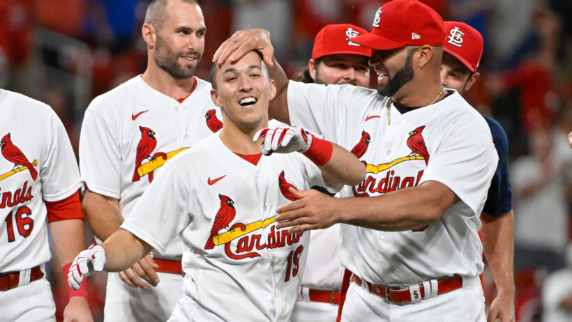 St. Louis Cardinals shortstop Tommy Edman is congratulated by teammates after hitting a game-winning double
