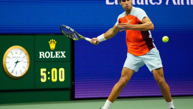 Carlos Alcaraz hitting a forehand during a tennis match at the US Open.