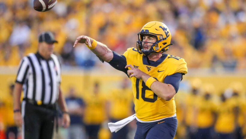 West Virginia Mountaineers quarterback JT Daniels throws a pass