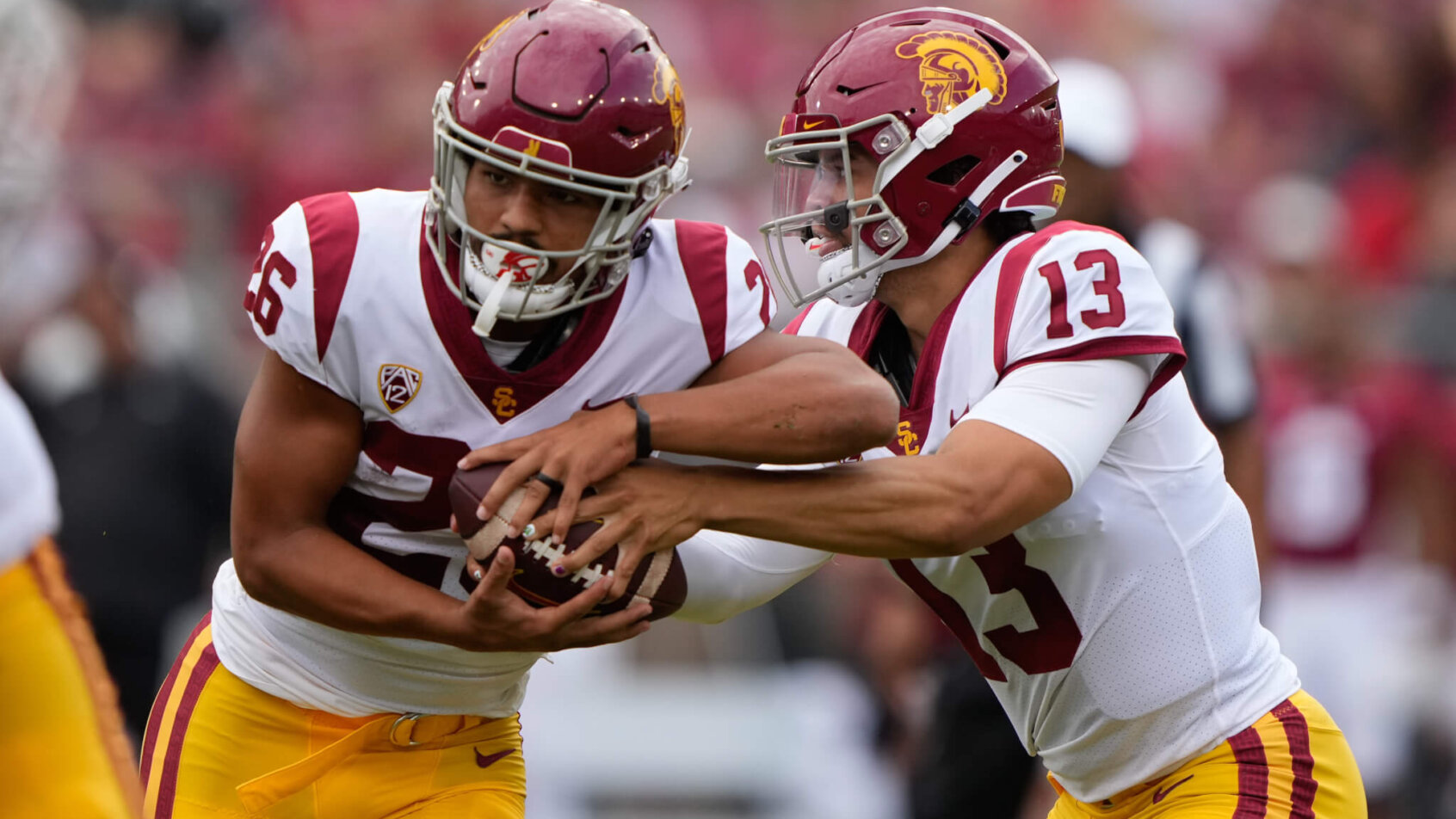 USC Trojans quarterback Caleb Williams hands the ball off to running back Travis Dye