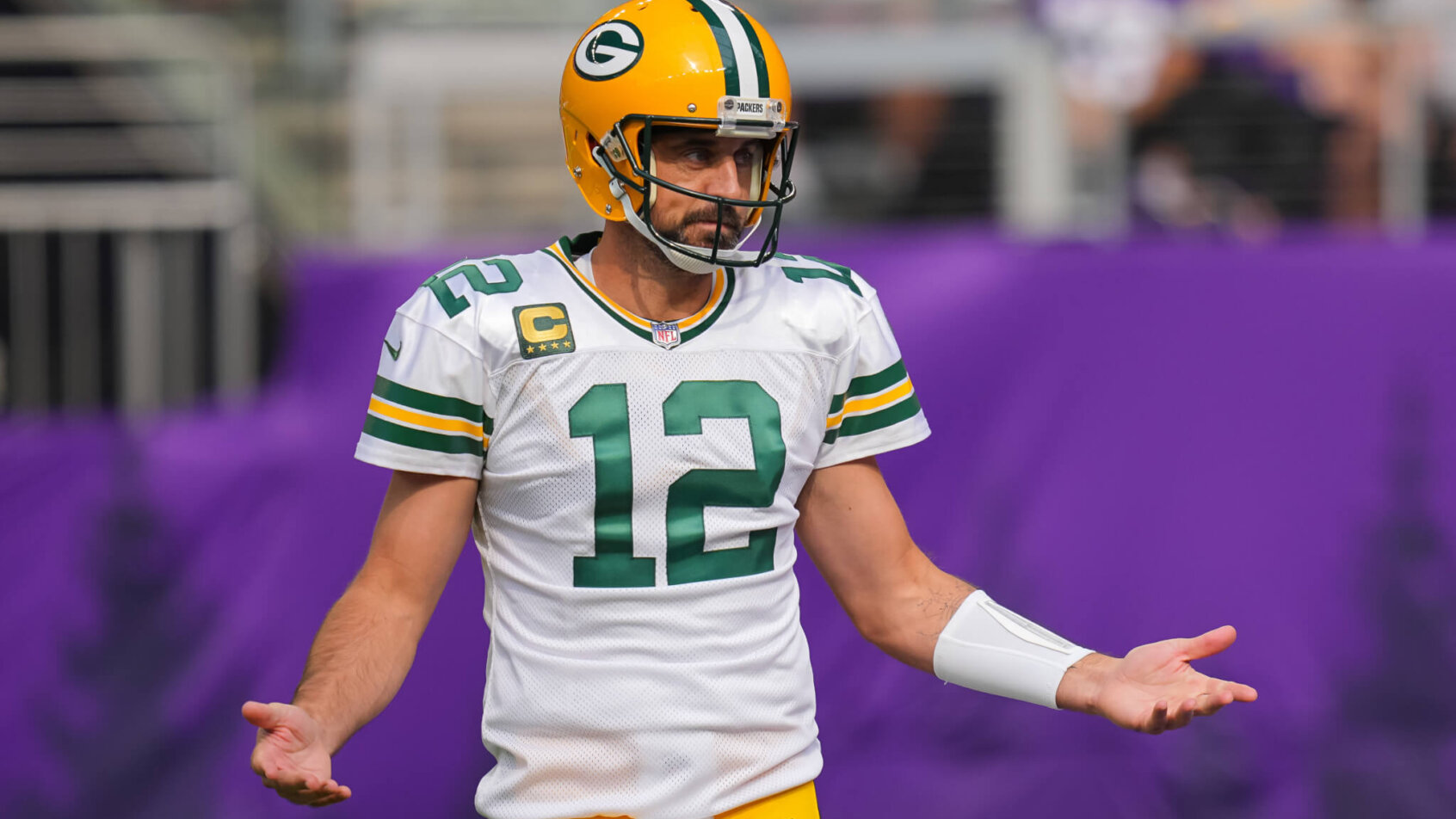 Aaron Rodgers arms out