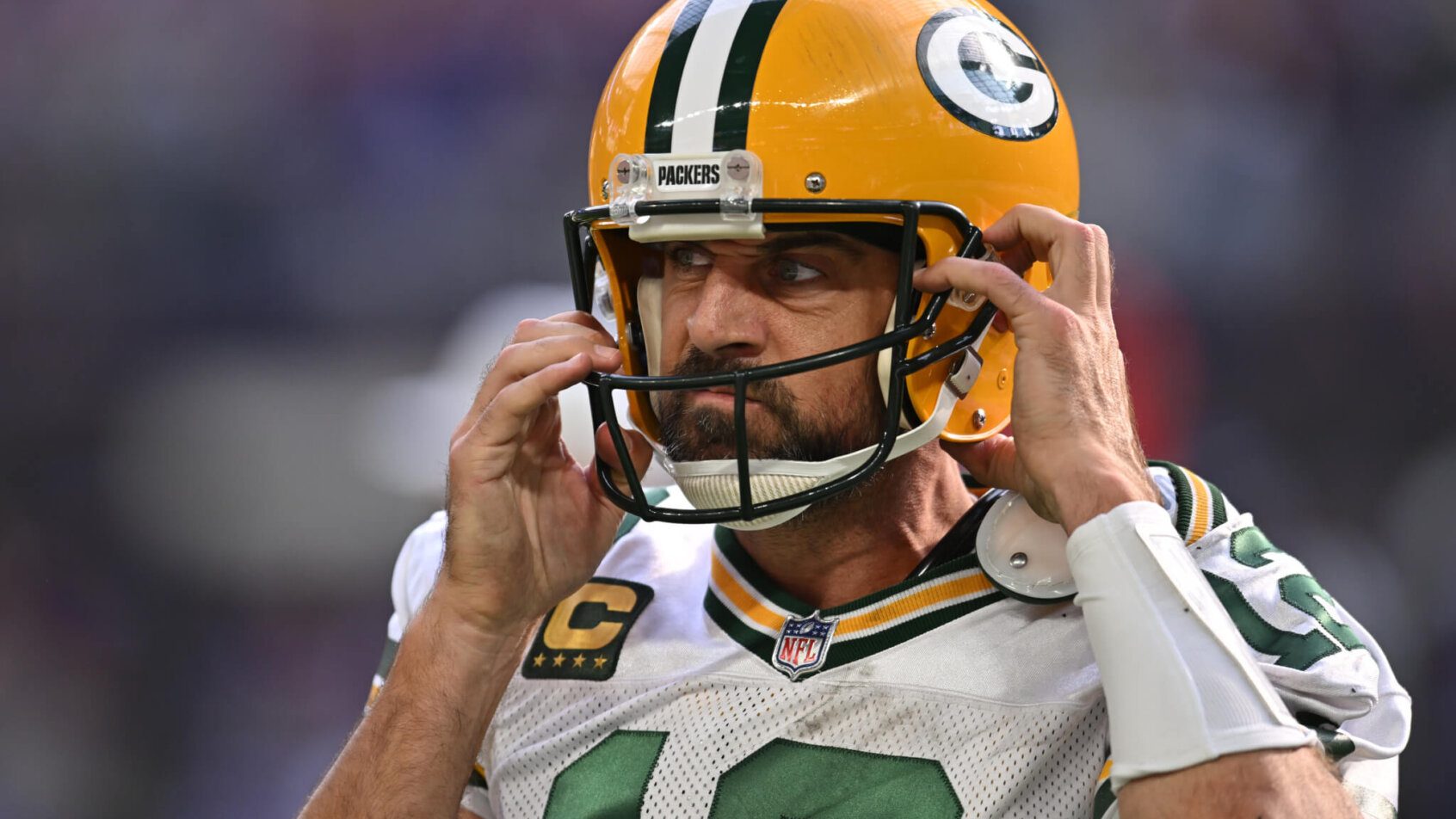 Aaron Rodgers adjusting helmet