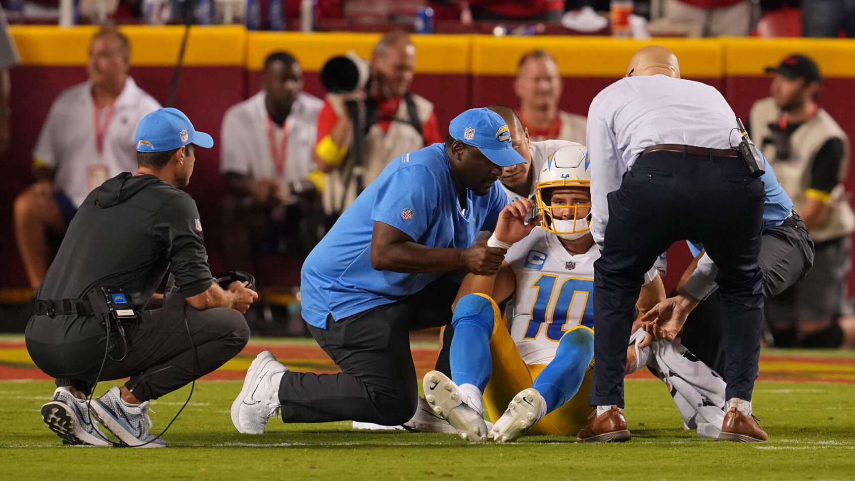 Justin Herbert gets checked out by the medical staff