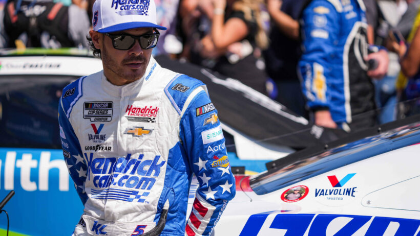 NASCAR Cup Series driver Kyle Larson leaning on his car