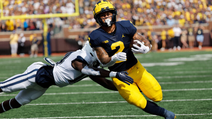 Michigan Wolverines running back Blake Corum rushes with the football