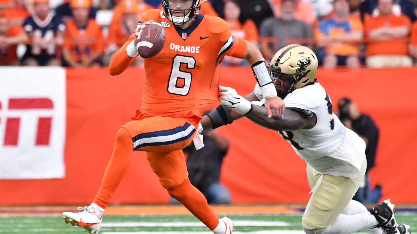 Syracuse Orange quarterback Garrett Shrader avoids a tackle