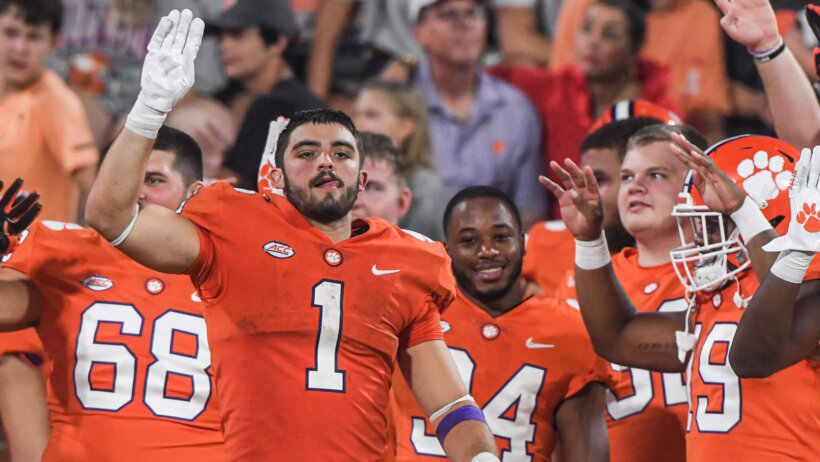 Clemson Tigers running back Will Shipley celebrates with teammates on the sideline