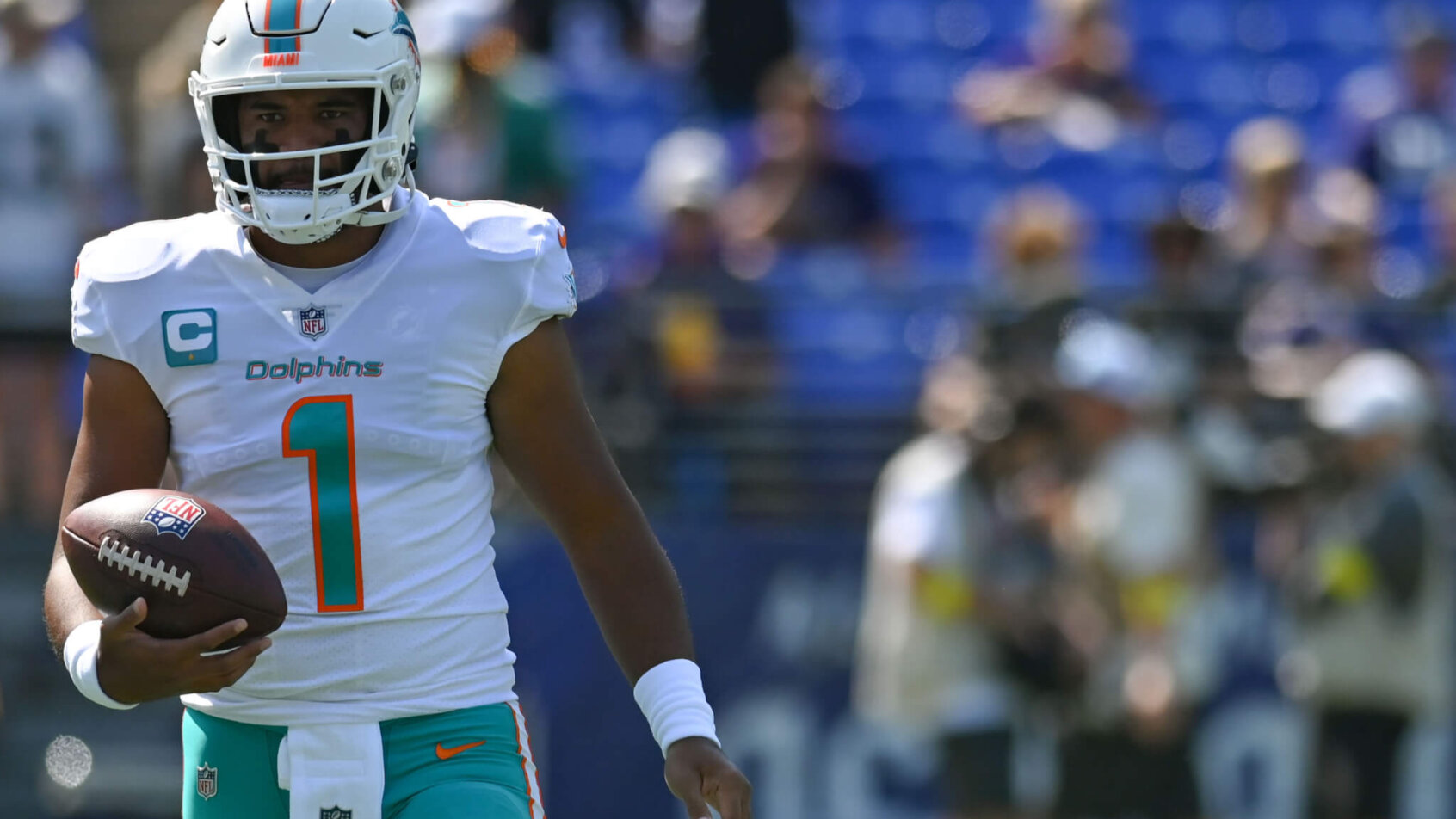Tua Tagovailoa holding football